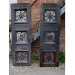 A pair of early 20th solid oak doors with cast iron glazed panels