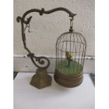 A 1920 German tin-plate clockwork automaton bird in cage on stand