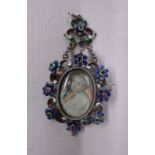 An antique necklace pendant with enamel decoration set with semi-precious stones and a central
