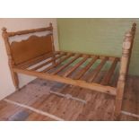 An antique pine double bed frame