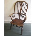 A 19th century elm seated Windsor style stick back chair