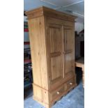 A pine double wardrobe with drawer base unit
