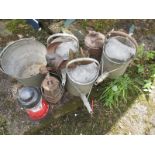 A quantity of vintage watering cans and other items