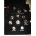 A collection of decimal and pre-decimal enamelled coins in fitted case