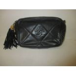 A 1980's leather clutch bag by Coco Chanel, number 0749038