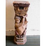 A carved wood pedestal with polychrome decoration