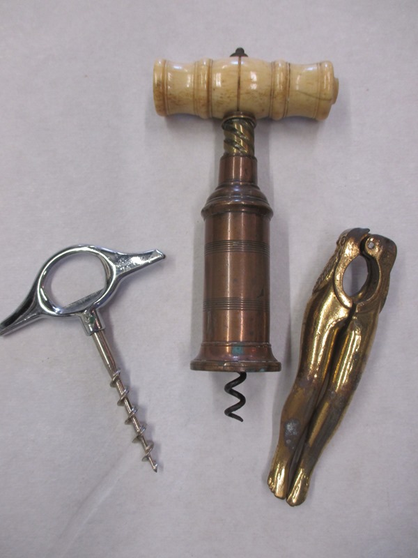 A 19th century corkscrew one other and a pair of legs nut crackers