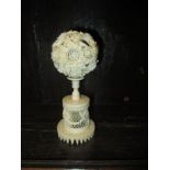 An early 20th century carved Ivory puzzle ball on stand