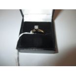 A yellow gold high set solitaire diamond ring