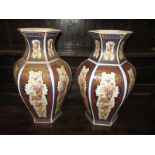 A pair of ceramic vases with panels decorated with peacocks