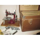 A vintage Essex miniature sewing machine in original case with accessories