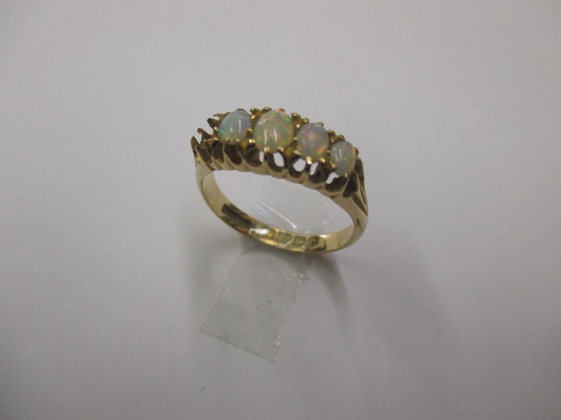 An 18ct gold and opal ring, one stone deficient