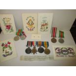 A group of 4 WWI medals, to include MM. 20830 PTE.E.W.Sutton A.CYC Corps, with other family medals