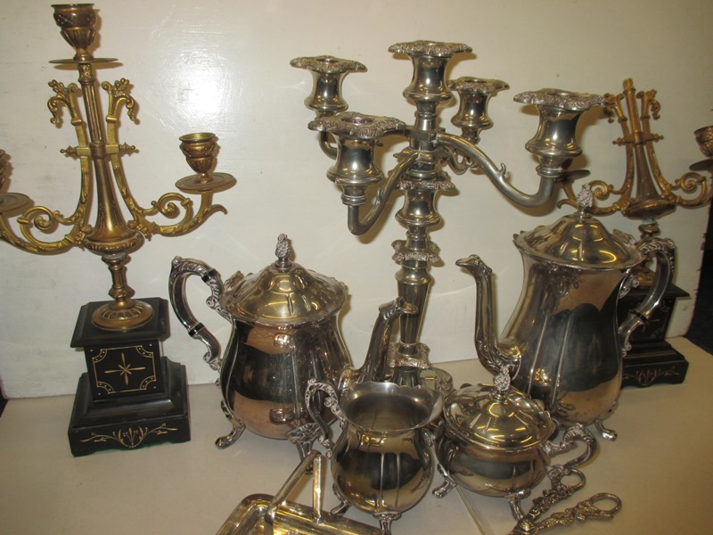 A quantity of plated items to include a 4 piece tea set and a 5 branch candelabra