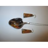 A large Baltic Amber necklace pendant and matching earrings