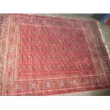 A vintage red ground wool rug