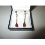 A pair of 9ct gold screw on earrings set with garnets