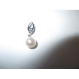 A 9ct white gold and pearl pendant