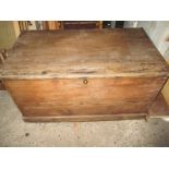 An antique stripped pine blanket box