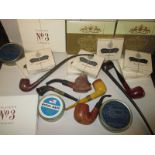 A quantity of smoking collectables to include unopened packets of cigarettes and pipes