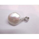 A large Baroque pearl set with an 18ct white gold mount