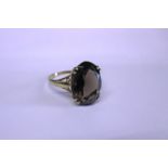 A 9ct gold ring set with a large smoky quartz stone