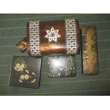 A mother of pearl decorated wooden box and four papier mache boxes
