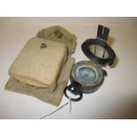 A WWII prismatic compass in pouch with 1944 crows foot mark