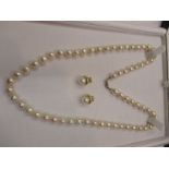 A Baroque pearl necklace with gold clasp and a pair of gold & pearl earrings