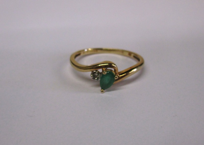 A 9ct gold diamond and emerald ring