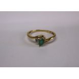 A 9ct gold diamond and emerald ring