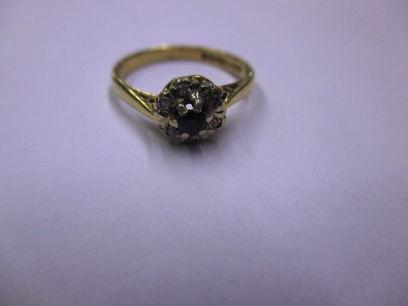 An 18ct gold diamond and sapphire ring