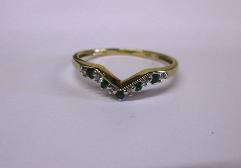 A 9ct gold diamond and emerald wishbone ring