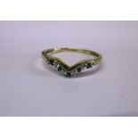 A 9ct gold diamond and emerald wishbone ring