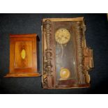 An wood cased wall clock and an inlaid mahogany smokers cabinet