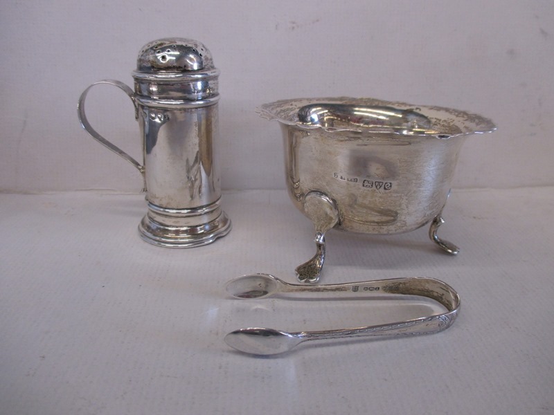 A late Victorian sterling silver cinnamon shaker and a 1930s silver sugar bowl