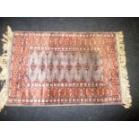 A small hand knotted North West Persian wool rug, approx size 65x100cm