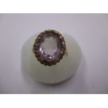 A 9ct gold ring set with a large amethyst