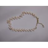 A cultured pearl necklace with 9ct gold mount