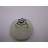 A 9ct gold daisy ring set with light blue topaz