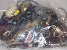 A Large Mixed Bag Of Costume Jewellery On Behalf O