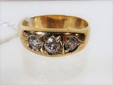 A Yellow Metal Three Stone Ring With Diamonds