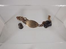 A Small 9ct Gold Bracelet With Two Silver Charms