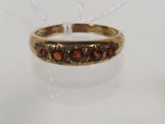 A 9ct Gold Ring With Garnets