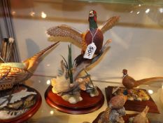 A Franklin Mint Porcelain Pheasant In Flight By A.