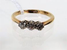 A 9ct Gold Ring With Three Small Diamonds