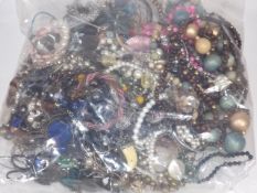 A Large Mixed Bag Of Costume Jewellery On Behalf O