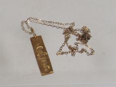 A Small Gold Pendant & Chain