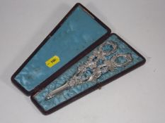 A Boxed Set Of Ornate Silver plate Grape Scissors