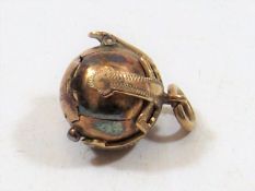 A Yellow Metal Charm With Maker Mark J.H.W